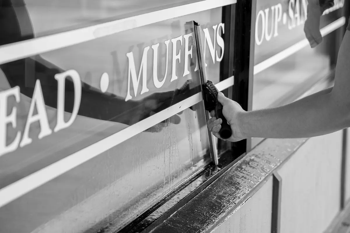 Squeegee pass across the Great Harvest window lettering