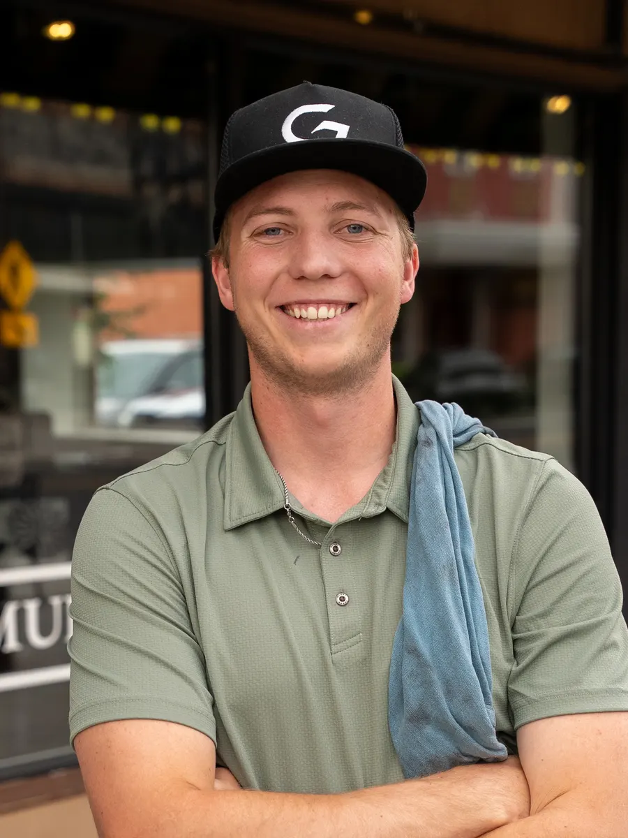 Lucas, owner of Clean Grit, outside a storefront in Logan
