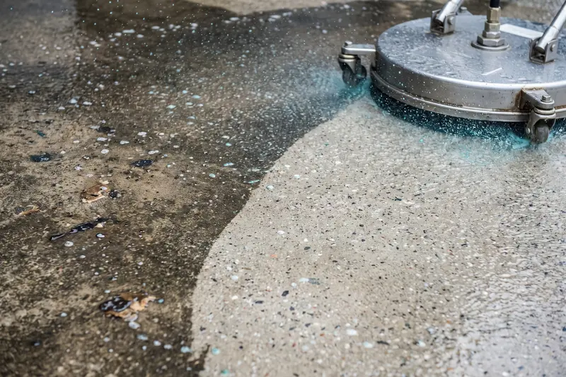 Close-up of gum and stain removal on commercial concrete in Logan, UT